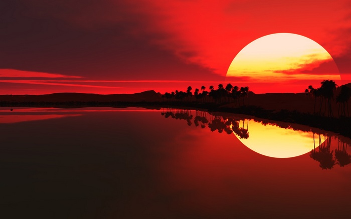 Red sun setting over a tropical landscape with reflection