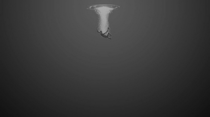 Monochrome image of a person falling underwater