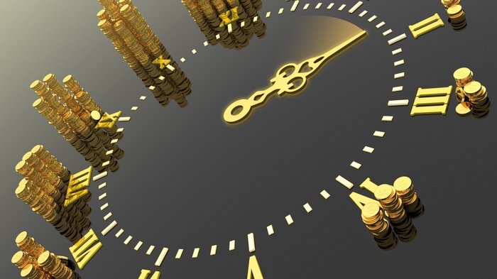 Gold coins stacked on a clock face representing time and money