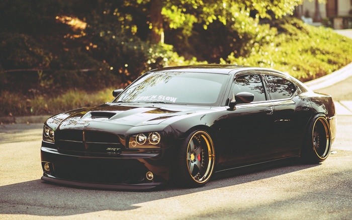Black Dodge Charger SRT with gold rims