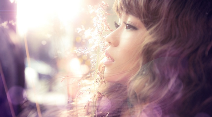 Asian woman with curly hair and flowers