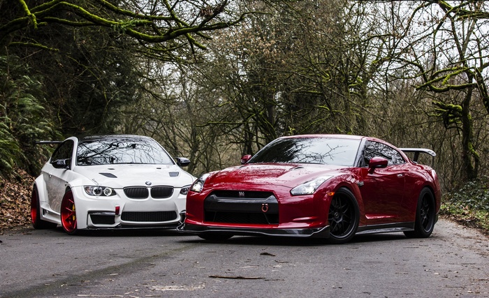 White BMW M3 and Red Nissan GTR on a Road