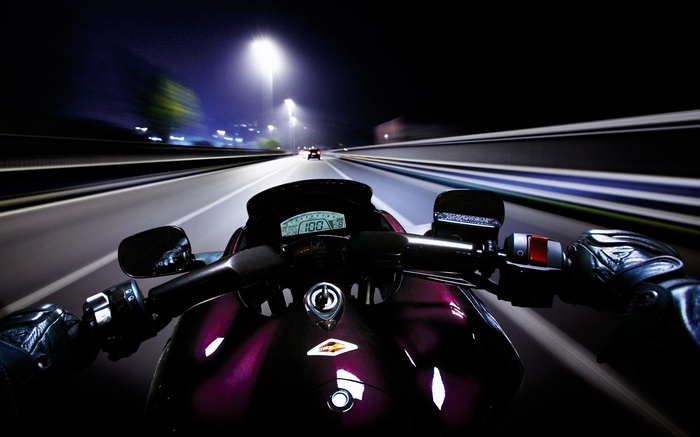 Motorcycle POV at night on a highway