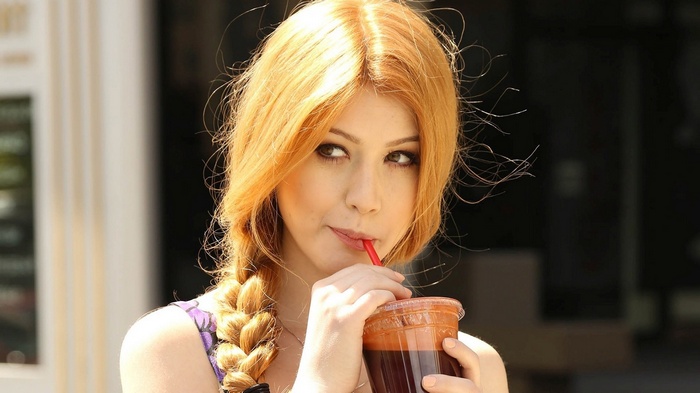 Katherine McNamara drinking a smoothie outdoors