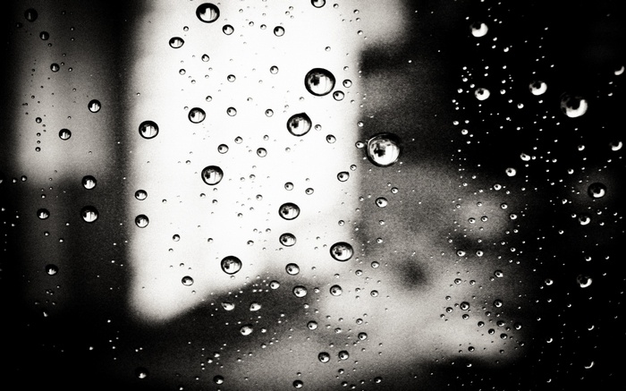Monochrome water drops on glass surface