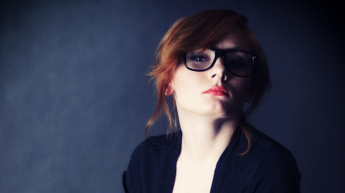 Woman with red hair and glasses