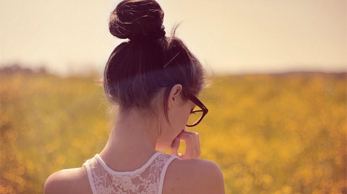 Woman with glasses in a field