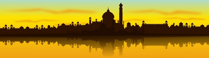 Silhouette of a city with domes and minarets reflected in water