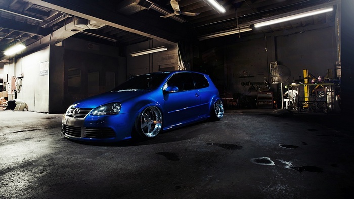 Blue Volkswagen Golf GTI in a garage