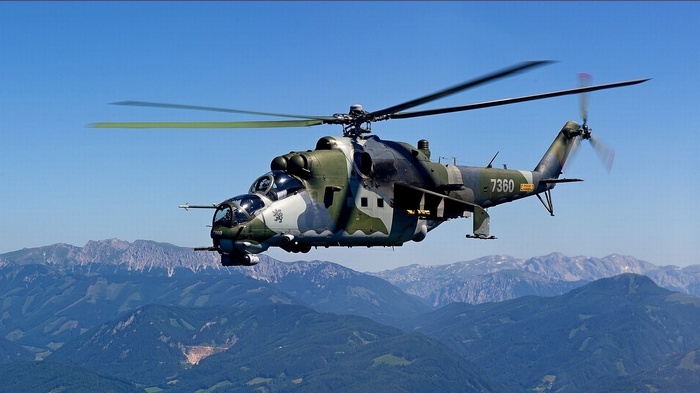 Mil Mi-24 Hind helicopter flying over mountains