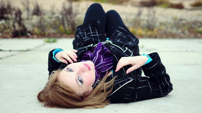 Woman lying on the floor outdoors