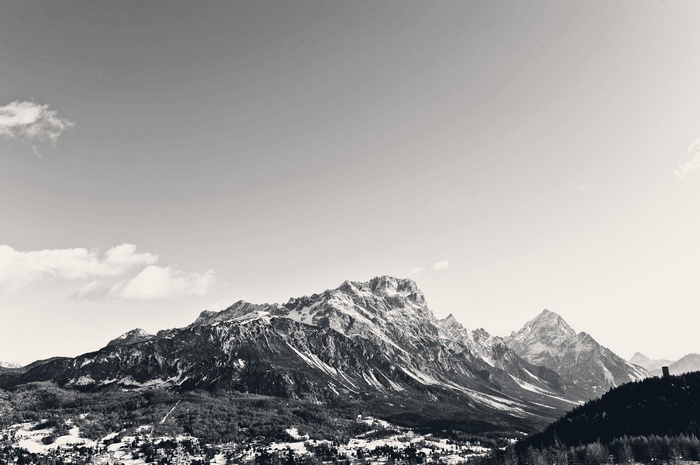 Monochrome landscape of snowy mountains under a clear sky