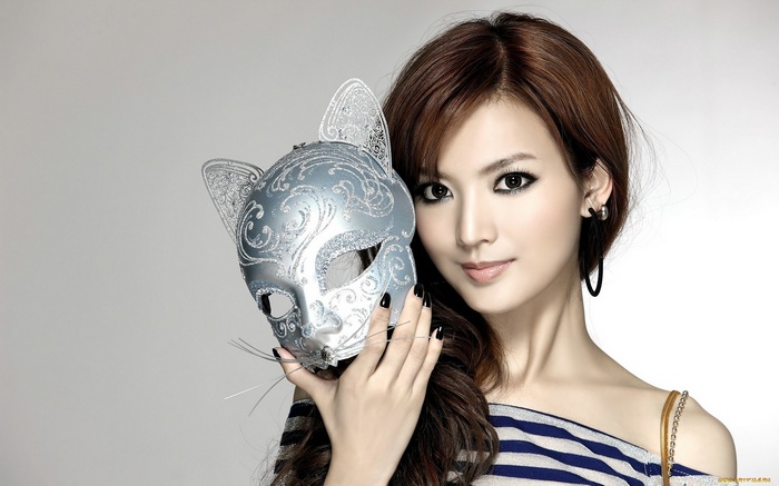 Woman holding a cat-shaped Venetian mask