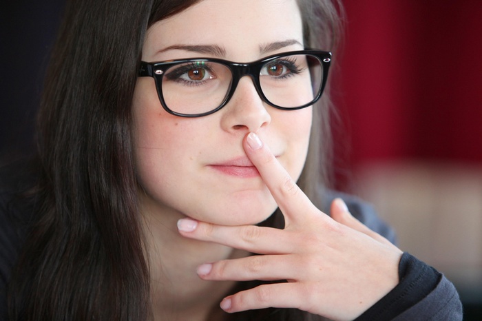 Lena Meyer-Landrut wearing glasses with finger on nose
