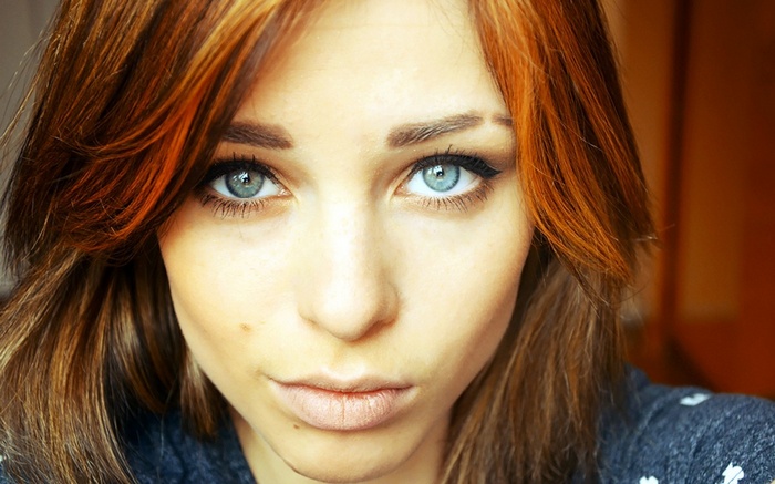 Lana Branishti with dyed red hair and blue eyes