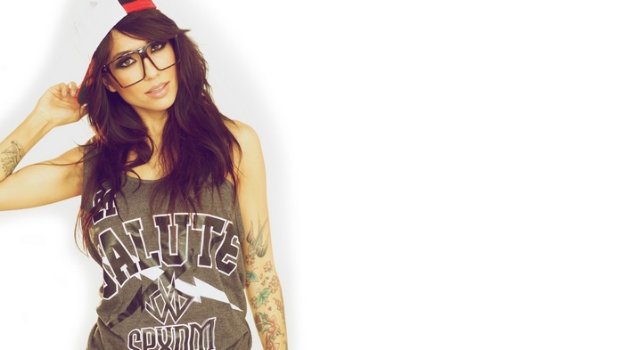 Alie Layus with tattoos and glasses