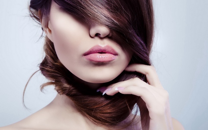 Woman with brown hair and pink lipstick
