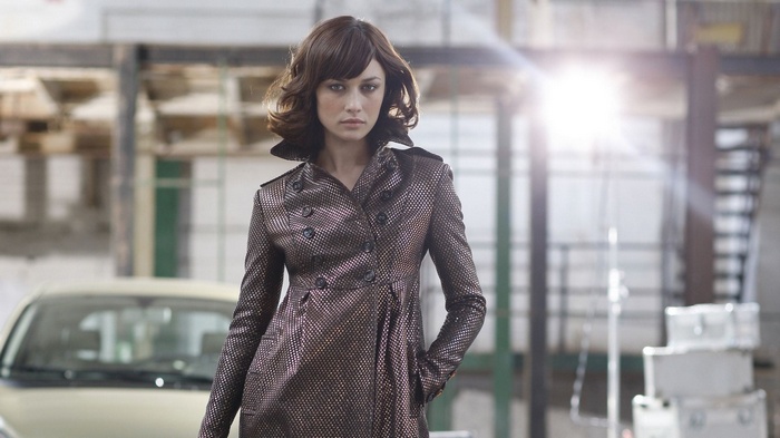 Olga Kurylenko in a metallic trench coat