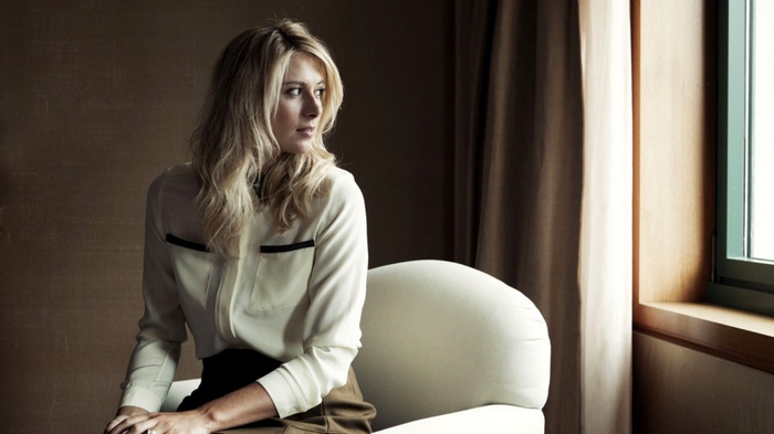 Maria Sharapova sitting on a chair indoors