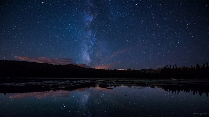 Milky Way over a reflective lake at night