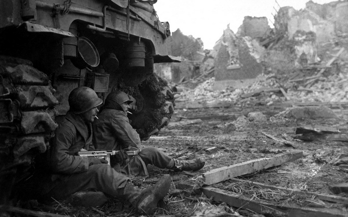 World War II soldiers with a tank in ruins