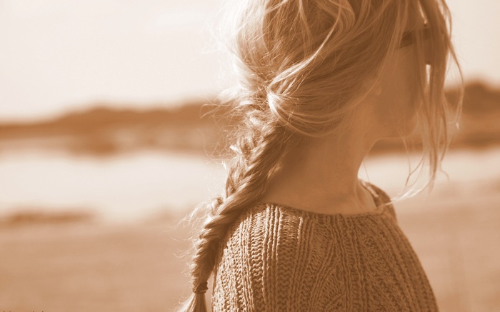 Woman with blonde braids in sepia tone