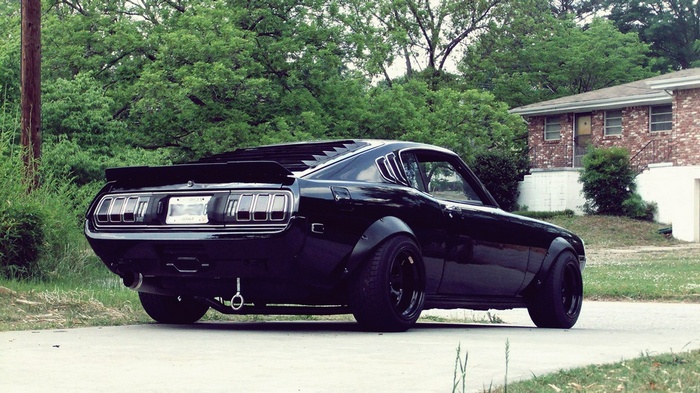 Black Toyota Celica with widebody kit on a street