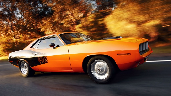 Orange Plymouth Barracuda driving on a road