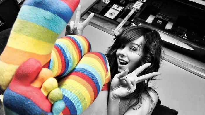 Ariel Rebel wearing colorful stockings and making peace signs