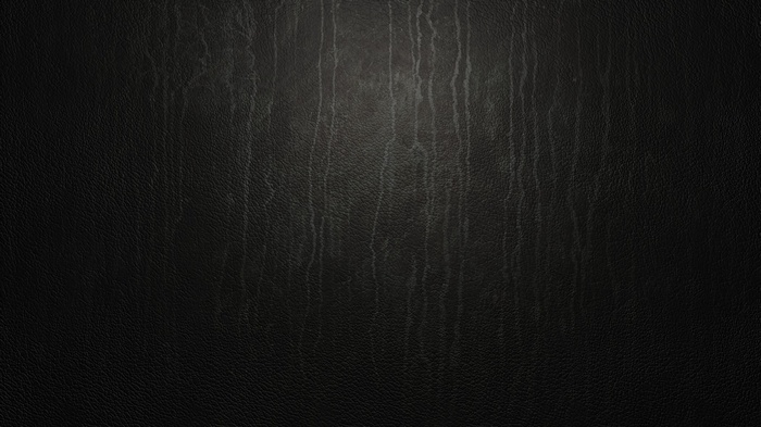 Dark textured surface with vertical streaks