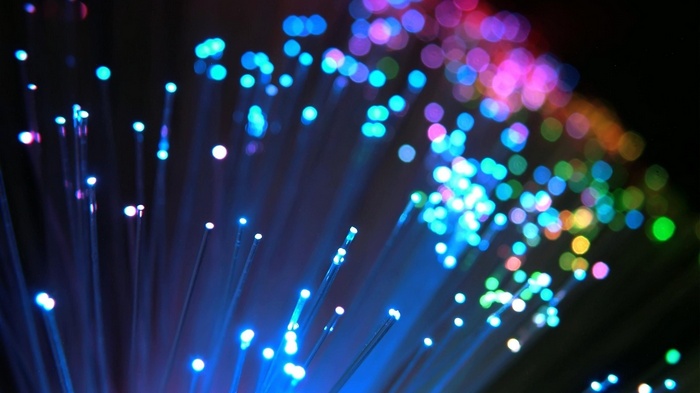 Close-up of colorful optic fibers with bokeh lights