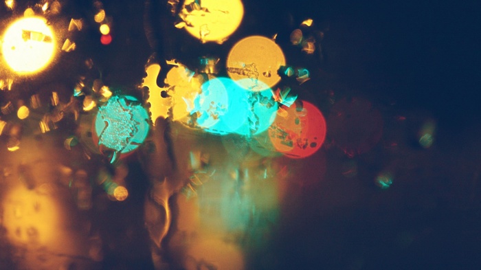 Bokeh lights on glass with water droplets
