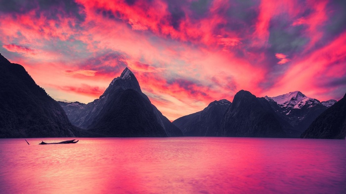 Milford Sound at sunset with dramatic pink clouds