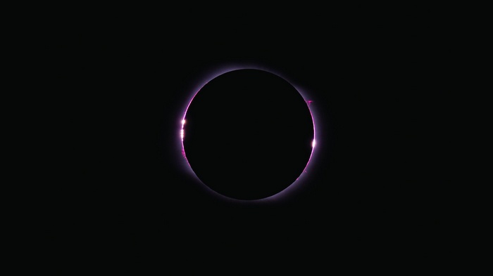 Total solar eclipse with pink corona