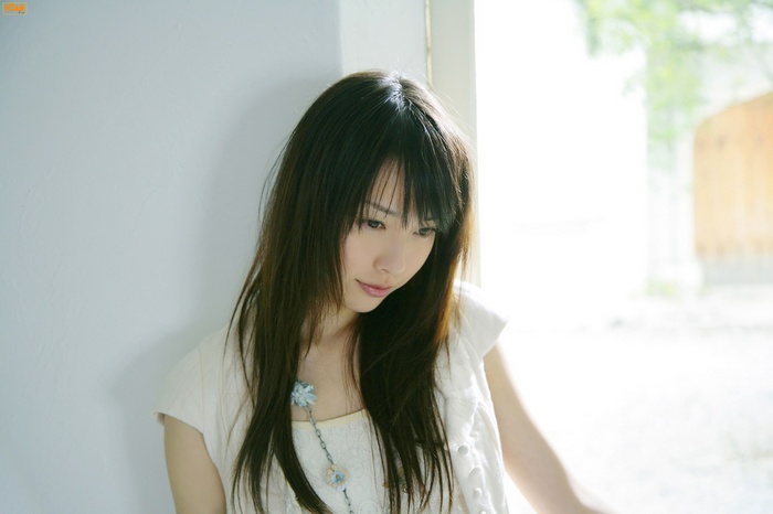 Erika Toda looking down with long dark hair