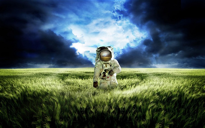 Astronaut standing in a field under a stormy sky
