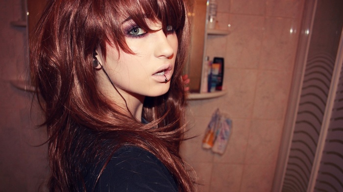 Niky Von Macabre with lip and ear piercings