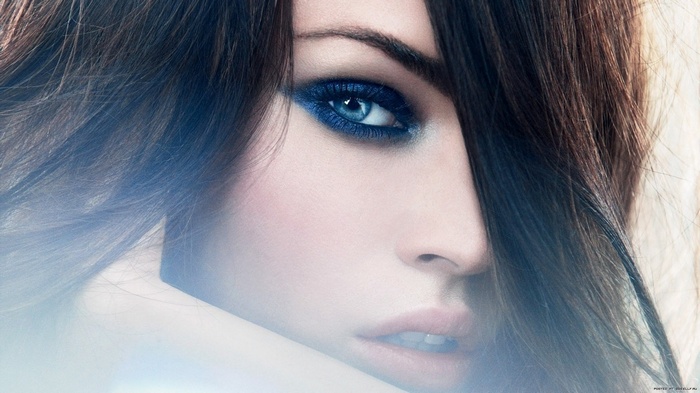 Megan Fox with blue eyeshadow and dark hair