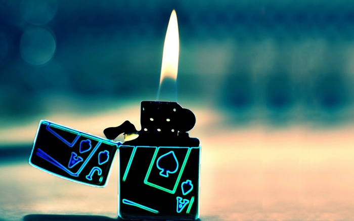 Lighter with playing card designs and flame