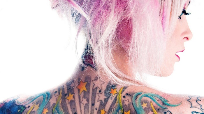 Woman with pink hair and star tattoos