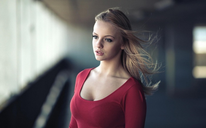 Woman with blonde hair wearing a red shirt
