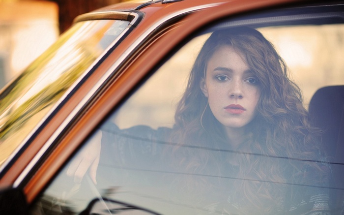 Woman with curly hair in a car
