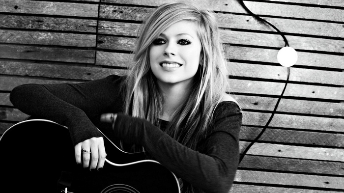 Avril Lavigne with an acoustic guitar
