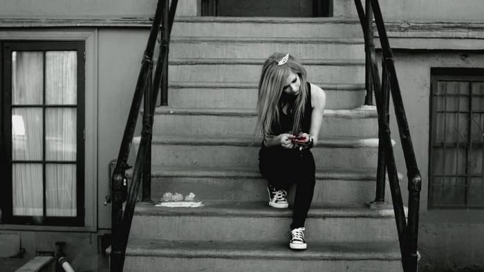 Avril Lavigne sitting on stairs