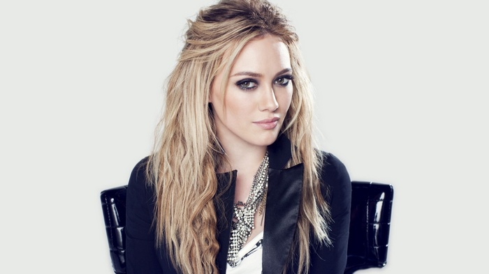 Hilary Duff wearing a black jacket and necklace