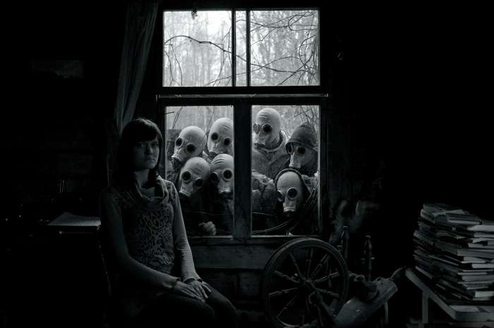 Woman with gas masks looking through a window