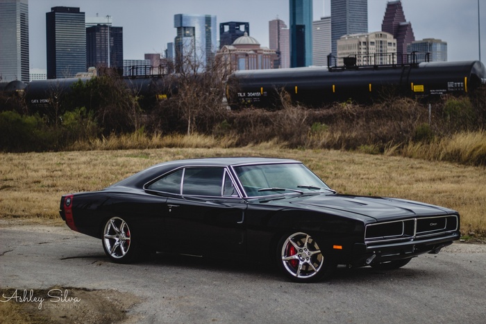 Black Dodge Charger with City and Train Background