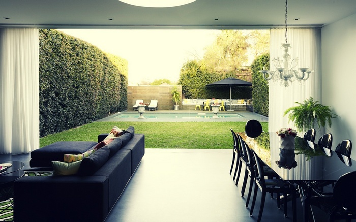 Modern living room with view of backyard swimming pool