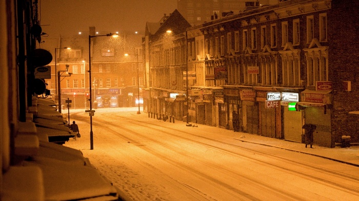 Snowy street in a city at night