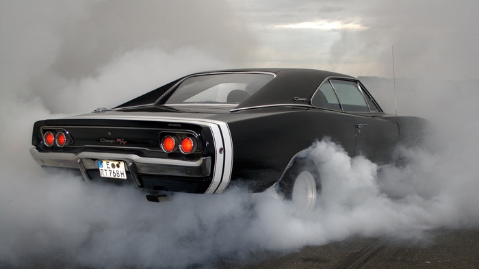 Black Dodge Charger performing a burnout